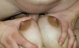 Husband fuck his busty brunette wife between her breasts