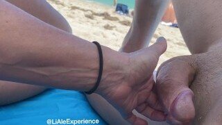 My hot wife gave me a sensual handjob on a public beach